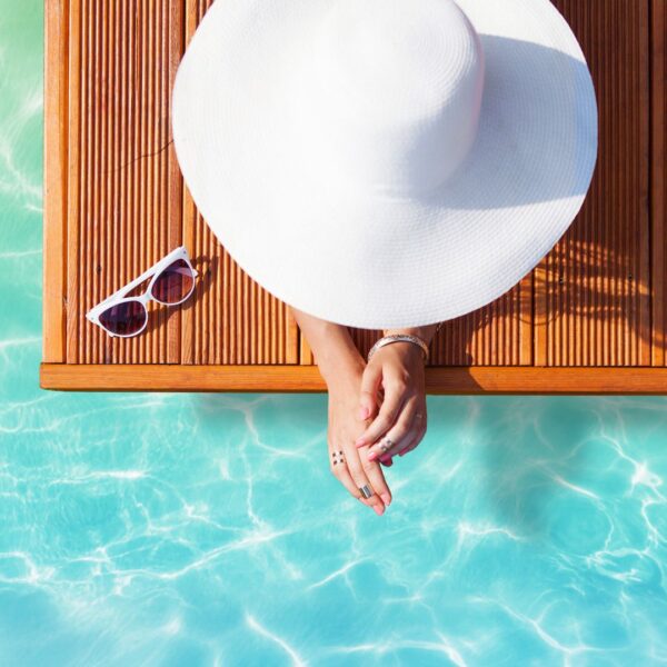 Woman wearing a hat at a pool