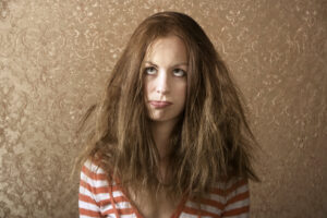 woman with frizzy hair needs Brazilian blowout